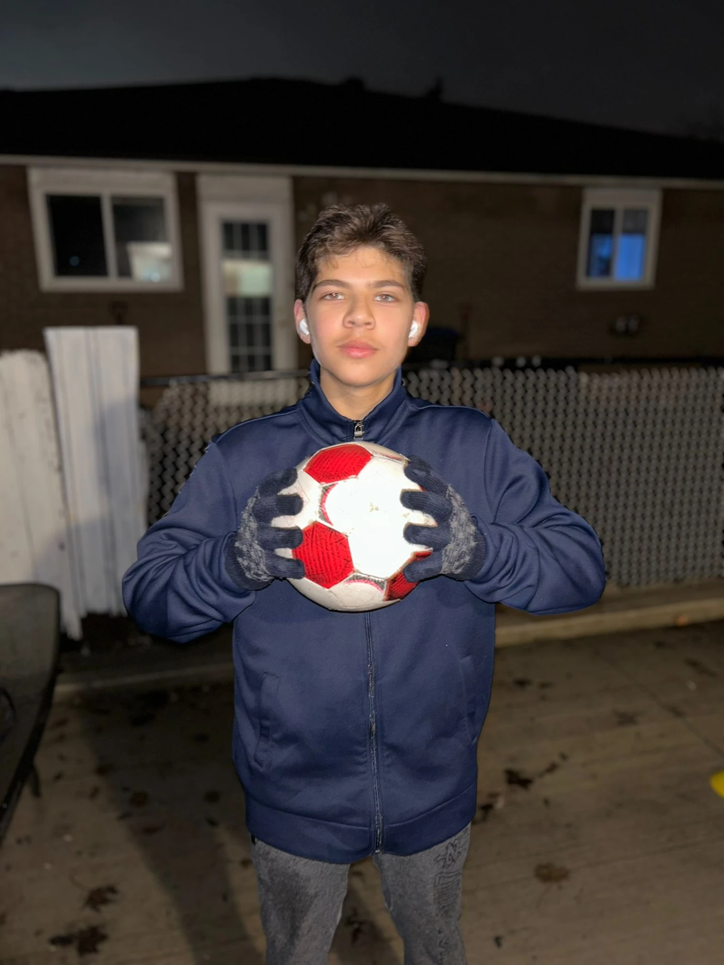 Sahain as a kid holding a soccer ball