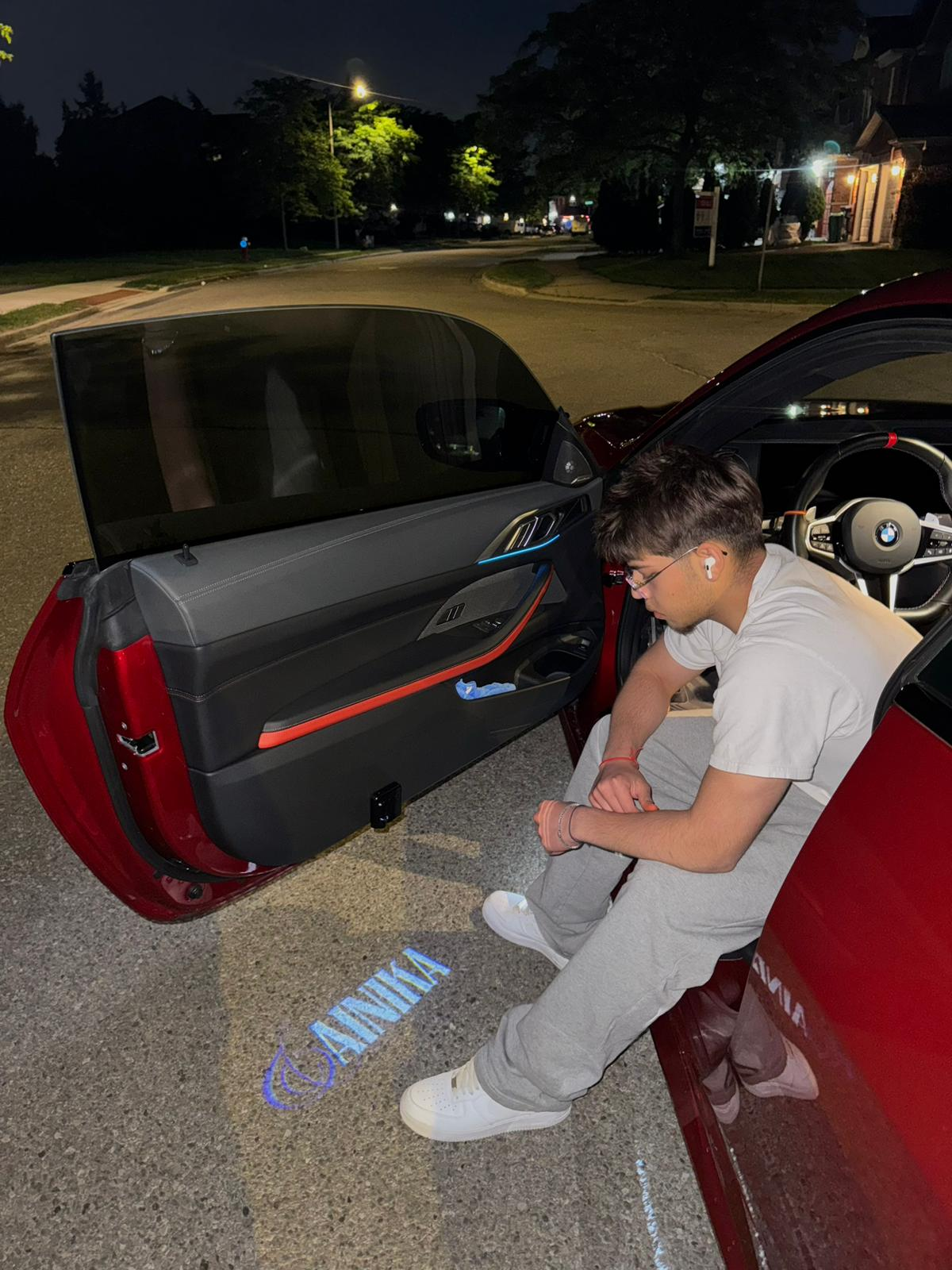 Sahain sitting in a car at night